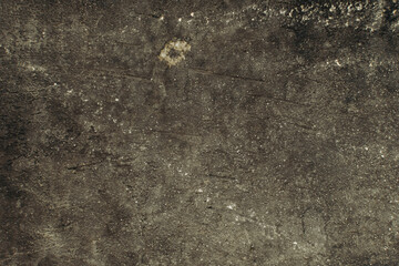 The background is made of an old worn, gray-black surface