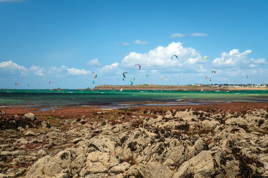 View of the coast of the city with beaches and kitesurfing enthusiasts on a sunny summer day, Saint-Malo, Brittany, France