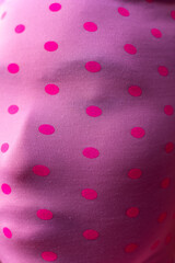 Woman wearing pink mask with many spots