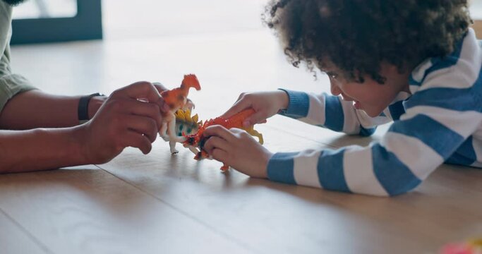 Father, son and playing with toy dinosours on floor for fun bonding, holiday or weekend at home. Hands of dad and little boy enjoying family time, pretend or dino fight in childhood together at house