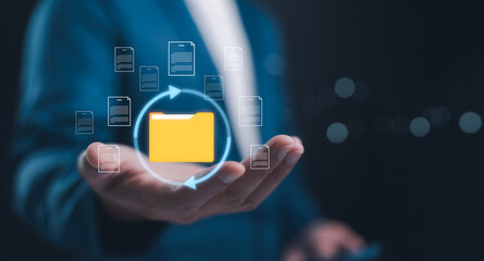 Document Management System concept. Online document file data software for efficient archiving. Businessman holding folder and document icon software, online documentation database and digital file.