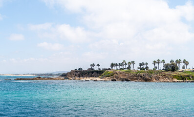 Remains  of stone buildings of an ancient cargo port on the shores of the Mediterranean Sea in Caesarea fortress in the north of Israel