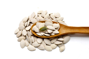 Roasted pumpkin seeds on white background.