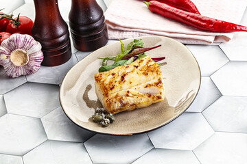 Roasted cod fish steak with salad