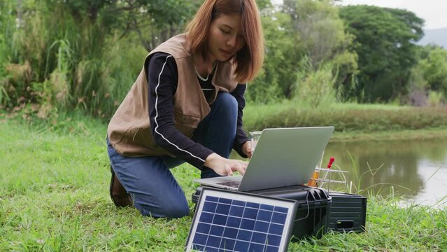 Women ecologist get sample of water from the river for water pollution test, ESG and environmental sustainability concept