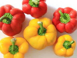 A bunch of fresh bell peppers on a white background