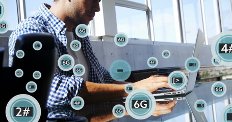 Image of 5g and 6g text with symbols over caucasian man working on laptop in office