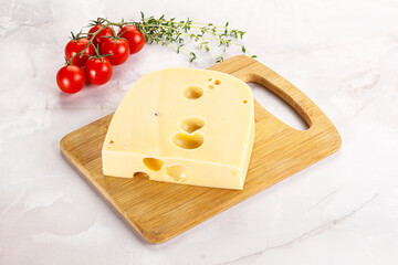 Maasdam cheese brick over board