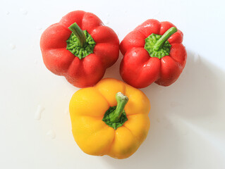 A bunch of fresh bell peppers on a white background
