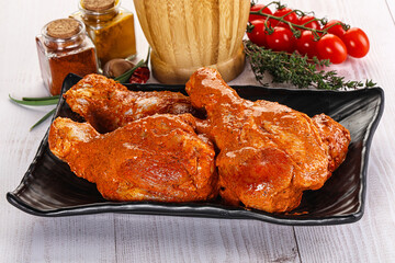 Raw turkey shoulder wing in Indian tandoori marinade