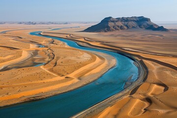 Fototapeta premium Winding river snaking through a vast desert landscape.