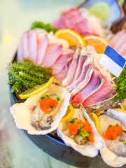 Raw fish slice and oyster serve with wasabi on the table