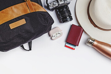 Travel essentials laid out including camera and passport