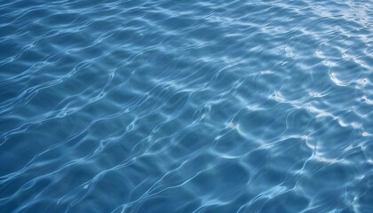 Obraz premium Blue ocean water with ripples caused by the wind