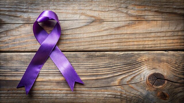 A delicate purple ribbon tied in a bow on a distressed wooden background, symbolizing domestic violence awareness and support.
