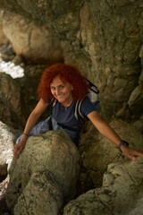 Woman hiker with backpack in the mountains