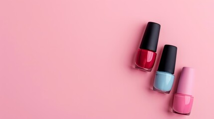 Obraz premium Top view of three different colored matte nail polishes with copy space for text on pink background. Manicure and pedicure ideas