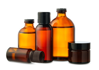 Amber Glass Bottles of Essential Oils and Cream Isolated on White Background