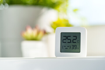 White Digital Thermometer Displaying Room Temperature and Humidity