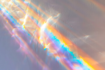 crystal prism rainbow light refraction texture on white wall background organic drop diagonal holographic flare on a white wall water shadows for natural light overlay effects