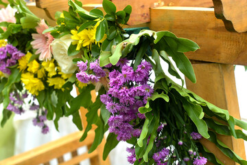 yellow, purple and  white flowers in a wooden box
