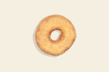 Cinnamon donut on coloured background