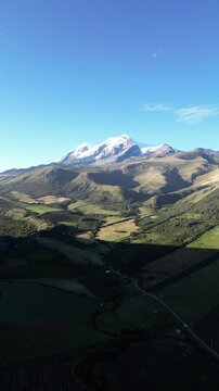Cayambe volcano drone view with green fields and mountains