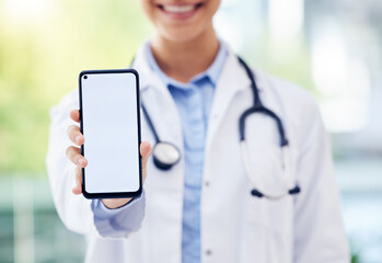 Happy doctor, hands and advertising with phone screen for healthcare app, service or telehealth at hospital. Closeup of medical employee with mobile smartphone display or mockup space for online help