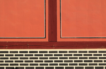 Front view of red wall and window door with wood muntin on a tile house of Changgyeonggung Palace near Jongno-gu, Seoul, South Korea
