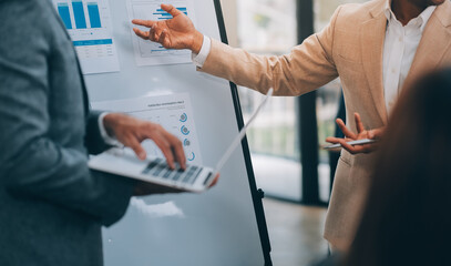 Obraz premium Young Businesspeople Working with Laptop in Modern Office. Office Workers at Work. Communication and Discussion at Work Concepts. Business Concept. Businessman and Businesswoman Concepts.