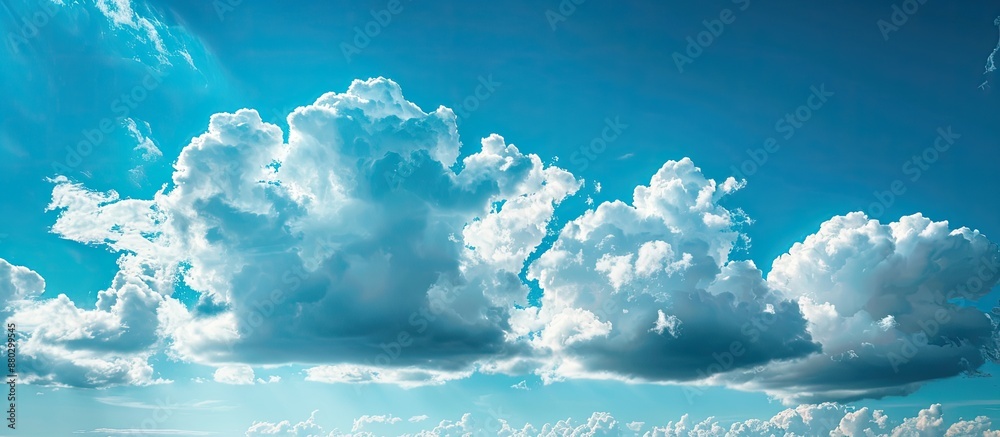 Poster the expansive blue sky adorned with fluffy white clouds, providing a serene backdrop for copy space 