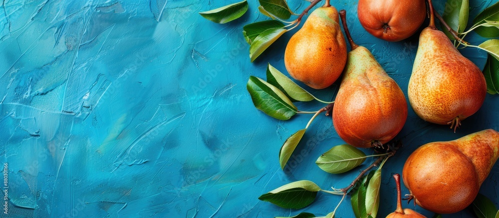 Poster Fresh pears and leaves set against a blue backdrop provide a vibrant composition with an inviting copy space image.