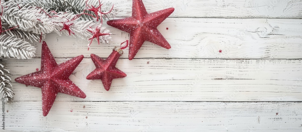 Poster on a white wooden surface, a festive display features a light pink garland with two red stars, creat