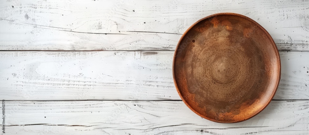 Aufkleber empty brown plate on white wooden table with ample copy space image.