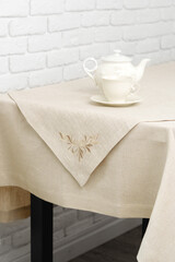 White Brick Wall With Beige Tablecloth and Basket