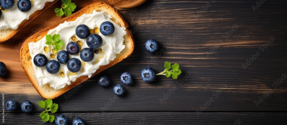 Poster Top view of delectable toasts with butter and blueberries on a rustic grey wooden table, with room for text in the image