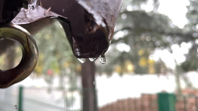 rain falling into old copper gutter with drops. High quality 4k footage