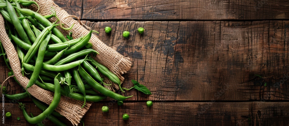 Poster fresh green beans arranged on a rustic tabletop with a copy space image in the background, perfect f