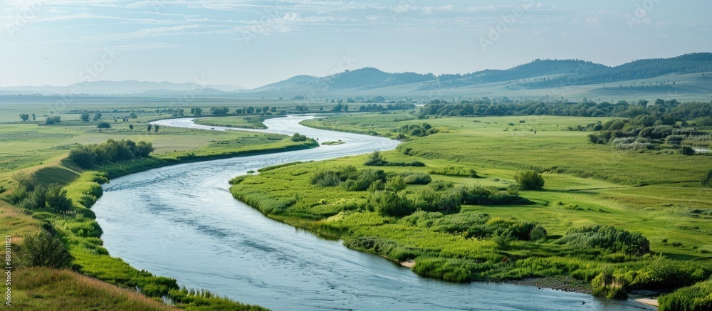 Poster A river meandering with a scenic view on one side and a vast and appealing blank space to be used for display or advertisement on the other side.