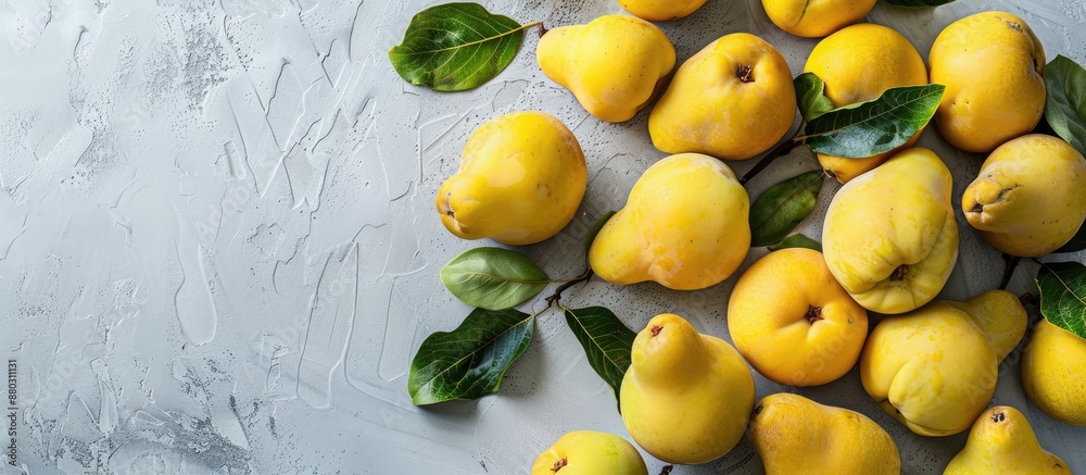 Poster A beautifully arranged display of organic quinces with leaves on a bright table in a flat lay style, offering ample copy space image.