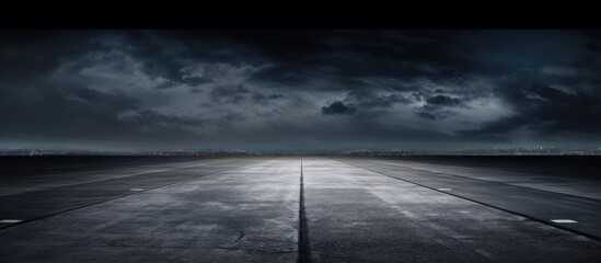 Fototapeta premium Night sky background over a dark concrete runway with street floor for copy space image.