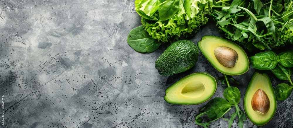 Poster An assortment of fresh green vegetables like avocado, lettuce, spinach, and arugula arranged on a table, perfect for a healthy meal or snack with a rustic background for a top view copy space image.