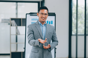 Fototapeta premium Young businessman giving presentation to his colleagues