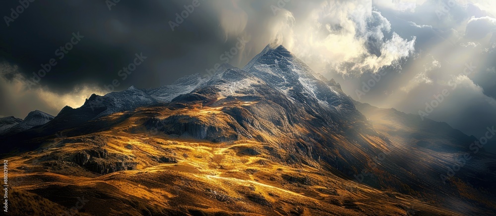 Poster Mountain bathed in sunlight showcases yellow and brown hues with dark clouds drifting in the background, featuring noise and grain in the copy space image.