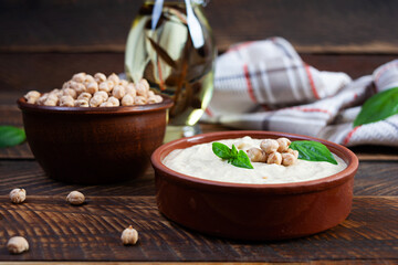 Eggplant hummus in a plate with basil. Chickpea dishes. Vegetarian food