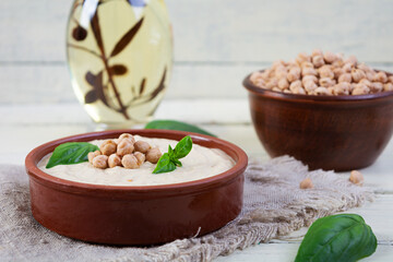 Eggplant hummus in a plate with basil. Chickpea dishes. Vegetarian food