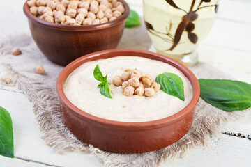 Eggplant hummus in a plate with basil. Chickpea dishes. Vegetarian food
