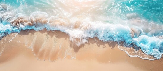Sunny tropical beach scene with a gentle sea wave rolling on the sand and plenty of copy space for adding text or images in the top down view
