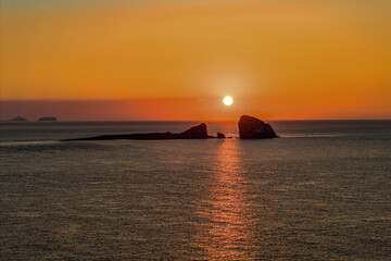 Aerial and sunrise view of Hyeongjeseom Islands on the sea against glow in the sky at Sagye Beach of Andeok-myeon near Seogwipo-si, Jeju-do, South Korea
