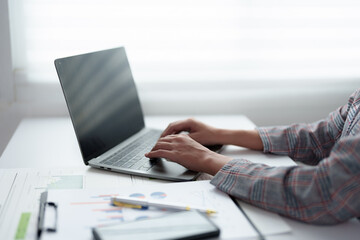 Beautiful business Asian woman working with laptop computer at desk small business owner online freelance worker Online marketing concepts, accounting, e-commerce.